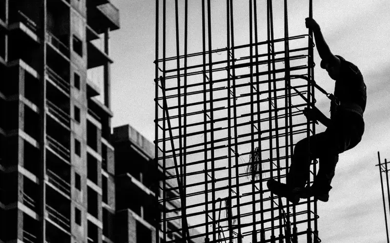 Man holding onto metal frame